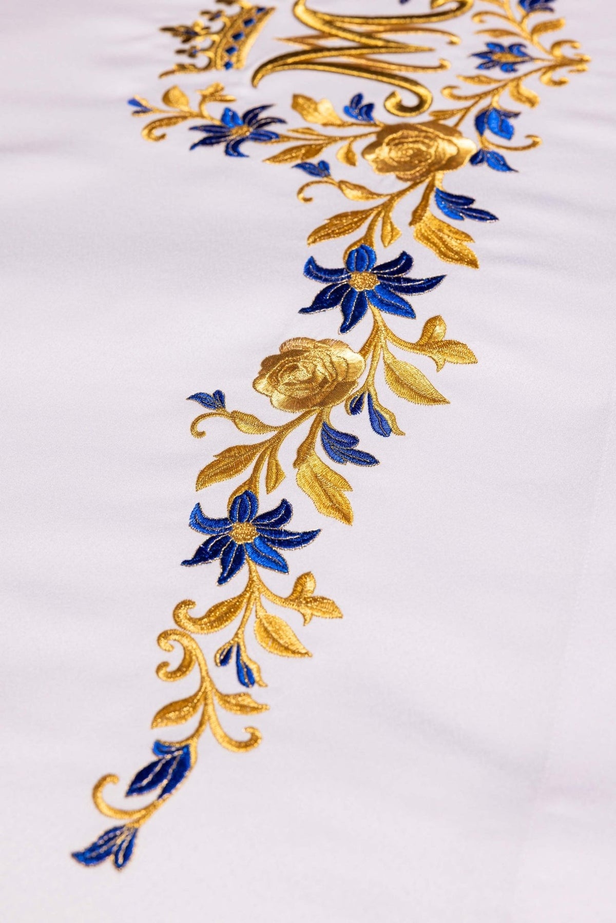 Altar cloth close-up showing blue flowers and gold rose embroidery