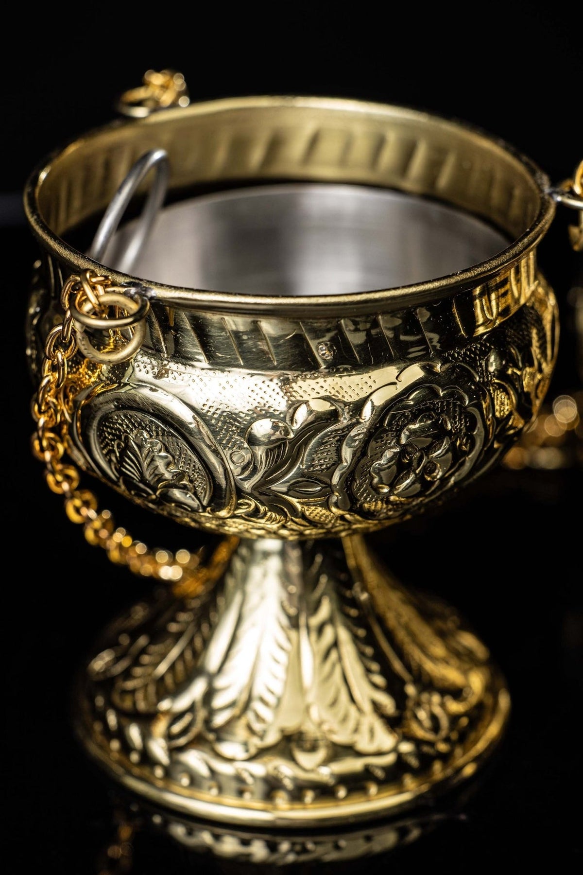 Brass thurible base close-up with embossed leaf details