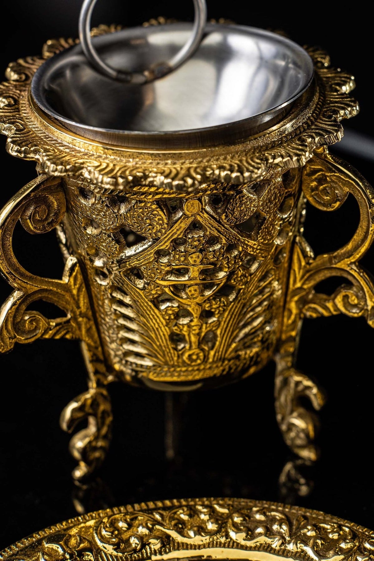Gold censer open bowl and ornate stand shown from above