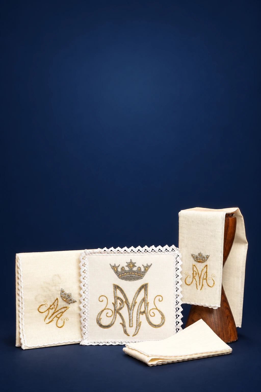 Marian altar linen set with embroidered crowned M monogram and lace trim, shown folded with one cloth displayed open