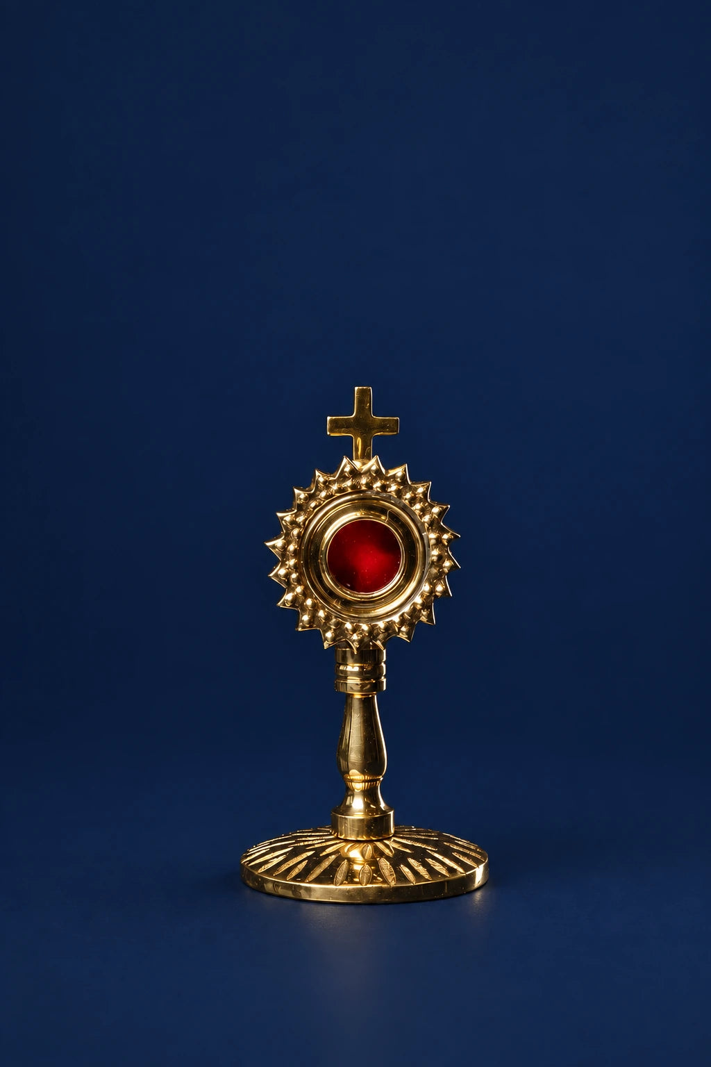 Brass Reliquary with Radiant Motif and Cross, full front view with red center and sunburst base