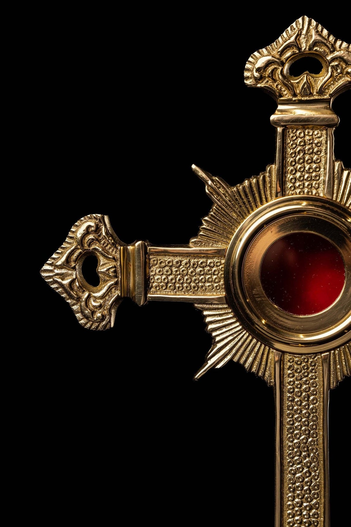 Brass cross reliquary close-up of left arm and radiant center