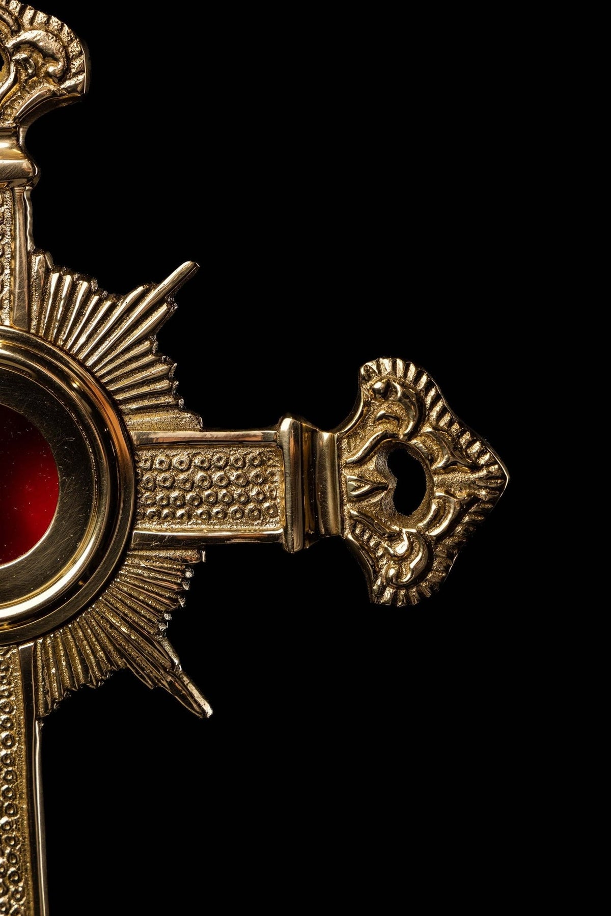 Brass cross reliquary close-up of right arm with ornate openwork end