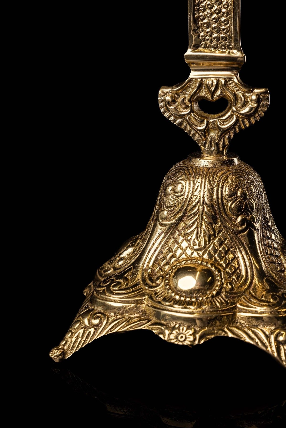Brass cross reliquary close-up of ornate decorated base