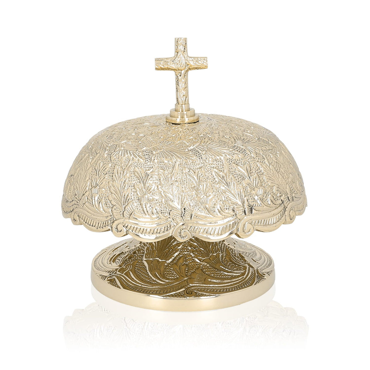 Brass altar bells, close front view showing floral engraving and cross finial