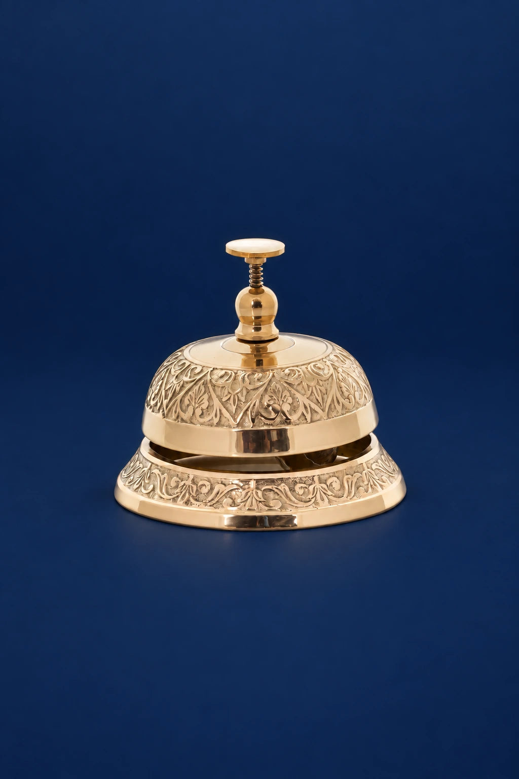 Brass altar bell with subtle botanical ornament, front view with engraved botanical bands