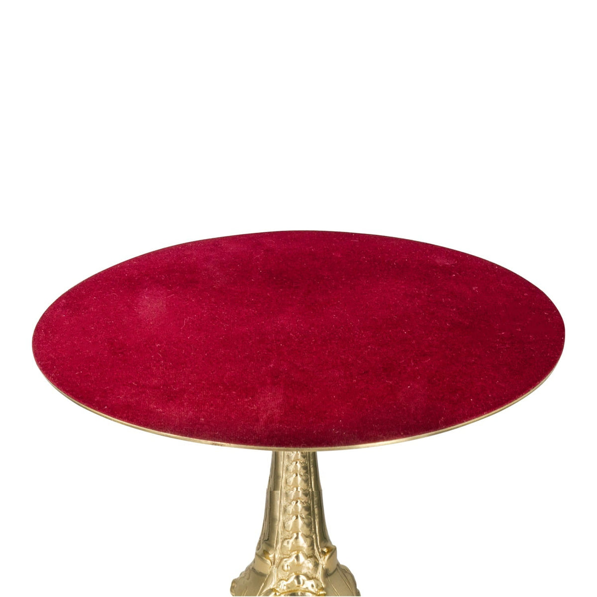 Thabor table close-up showing its red velvet oval surface and brass edge