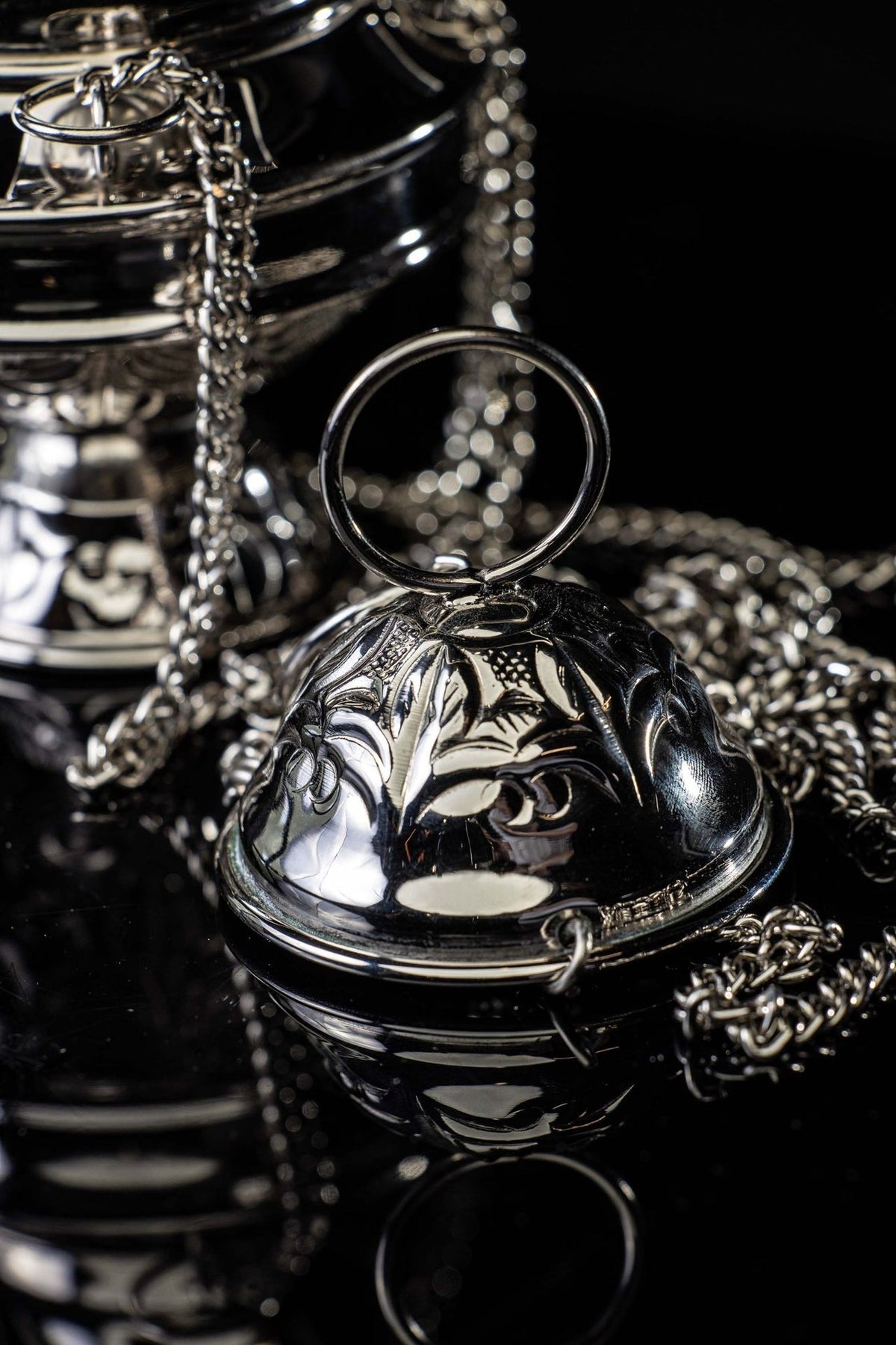 Nickel-plated brass thurible close-up of its linked hanging chains
