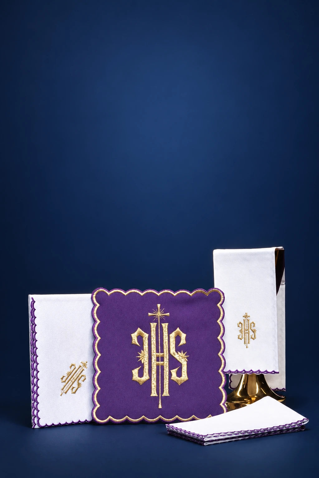 Purple embroidered altar linen set with IHS monogram and scalloped trim, shown folded and displayed front view