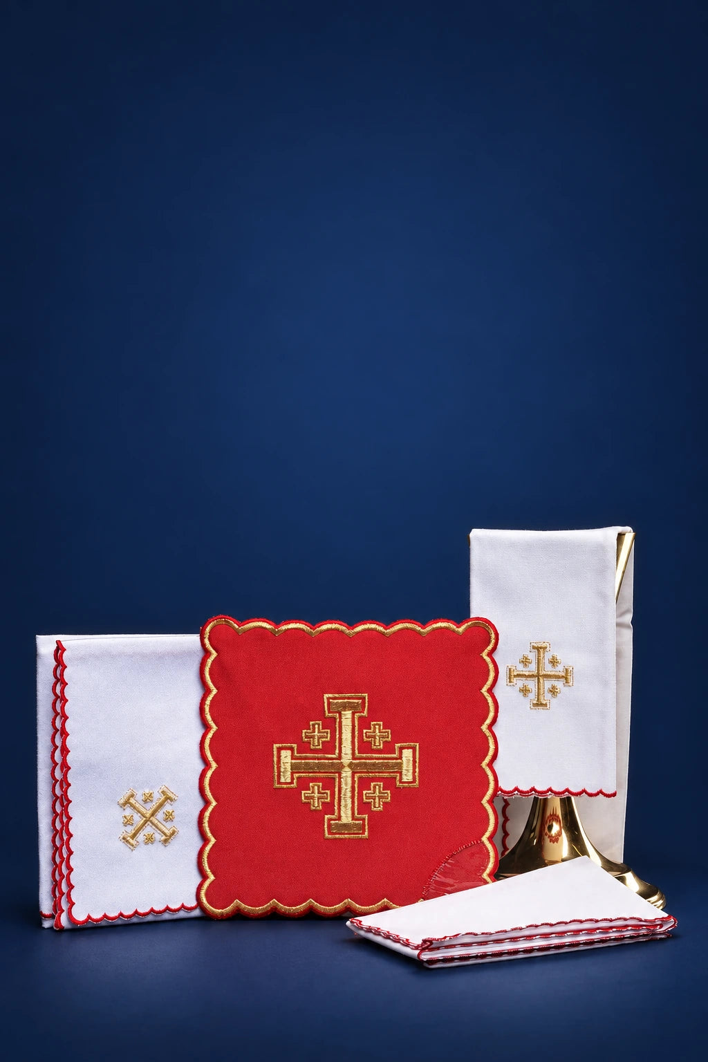 Red altar linen set with embroidered Jerusalem crosses and scalloped trim, shown folded