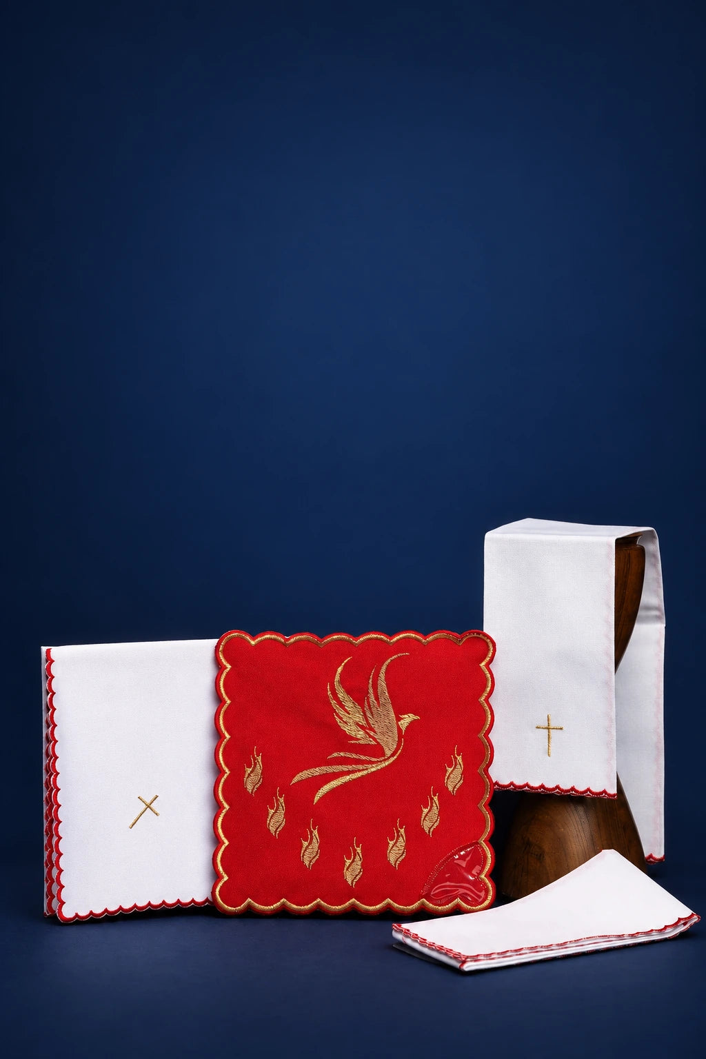Red altar linen set with pall showing Holy Spirit embroidery and matching cross-embroidered linens