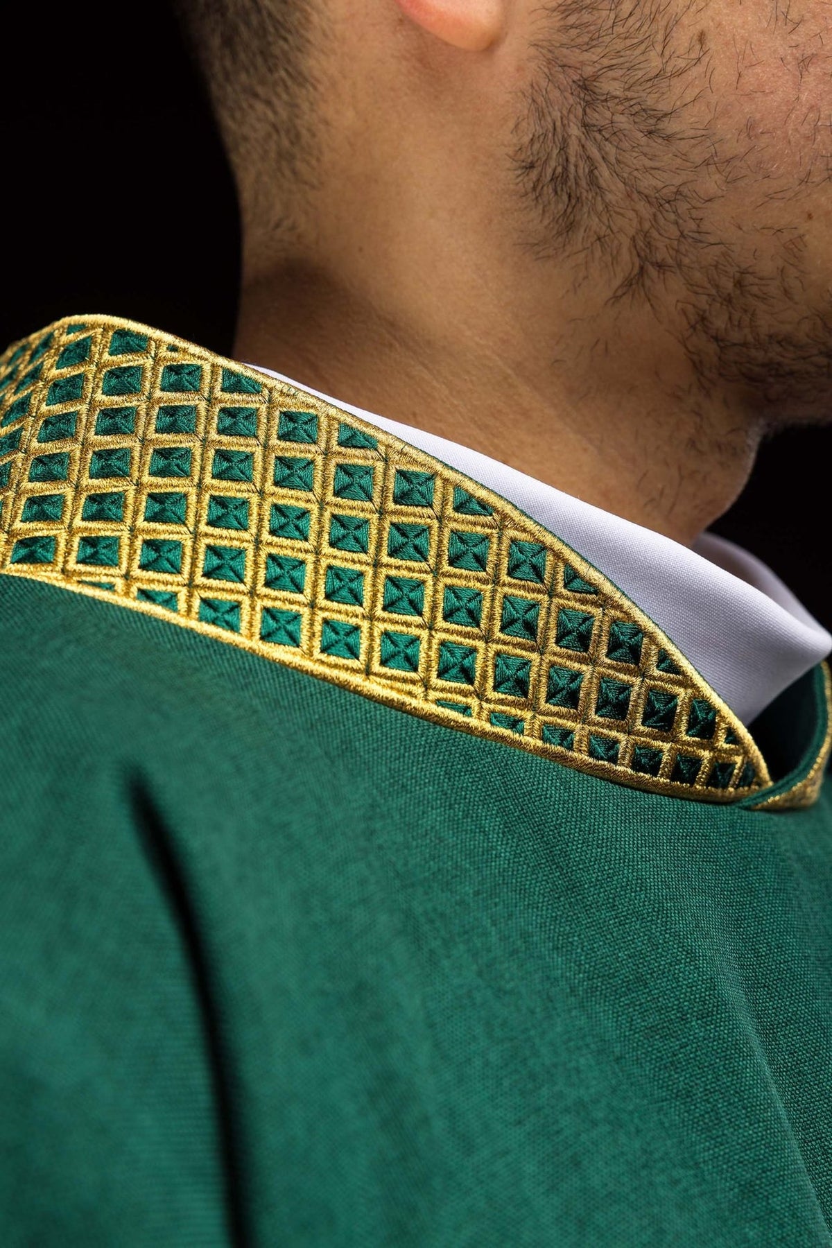 Green dalmatic close-up of embroidered gold collar with diamond pattern