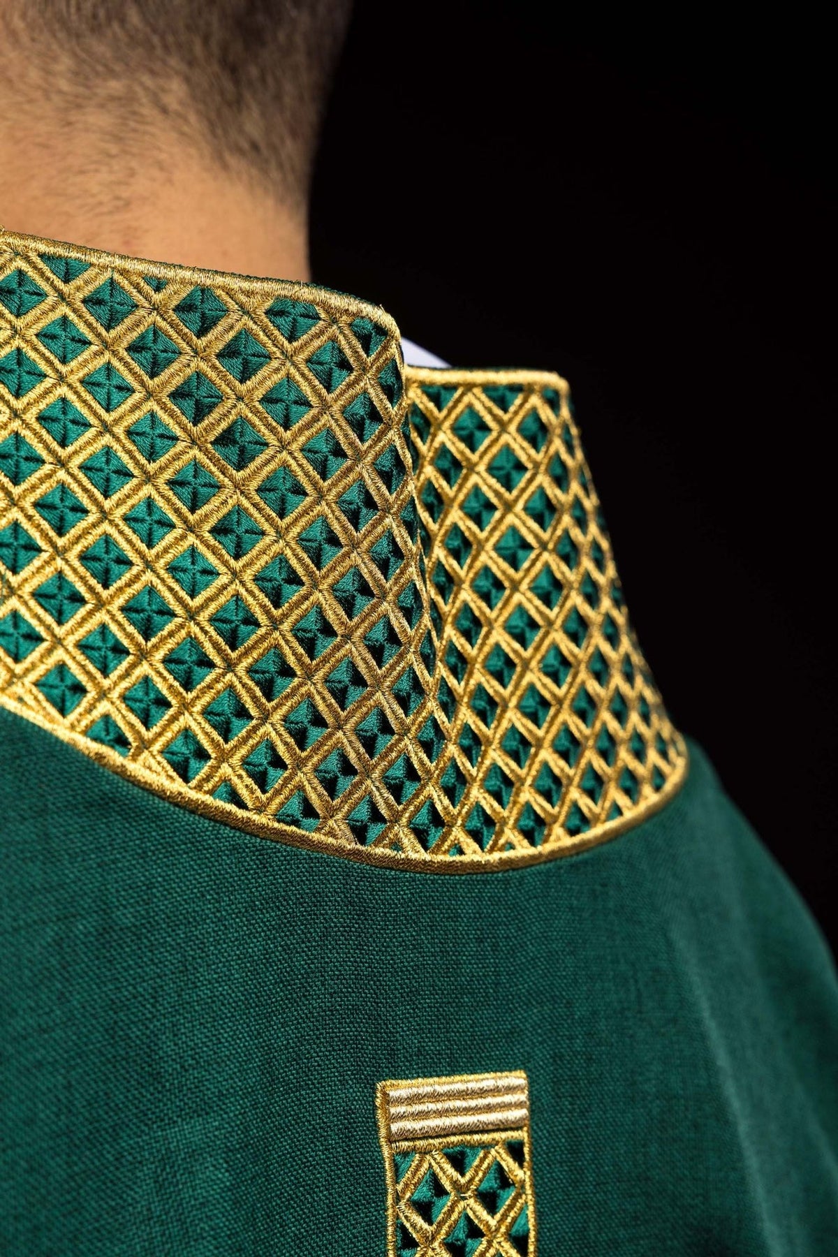 Green dalmatic close-up of gold embroidered collar and cross detail