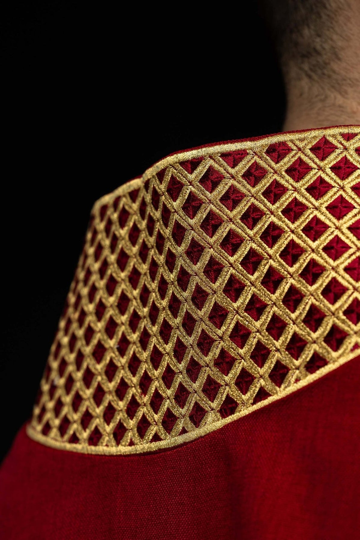 Red dalmatic collar and gold embroidery close-up