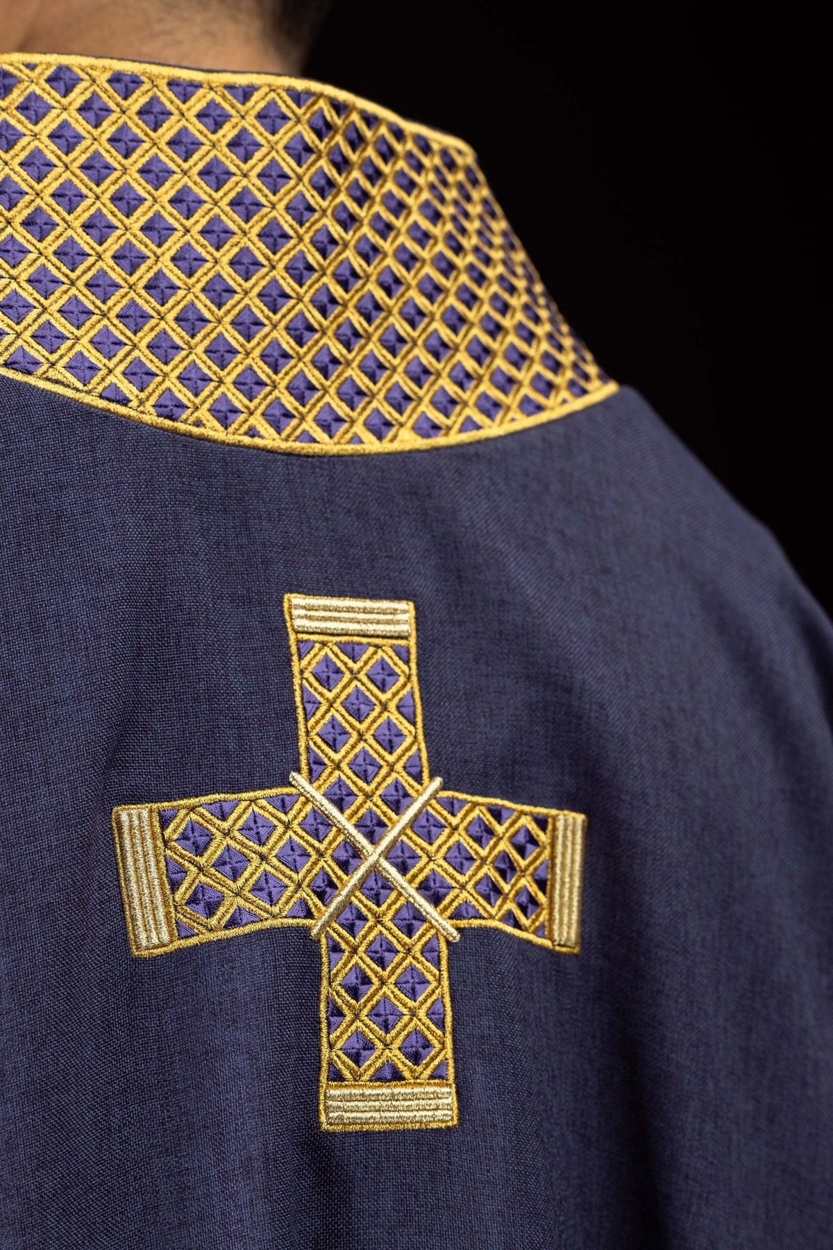 Purple dalmatic back close-up with embroidered gold collar and cross