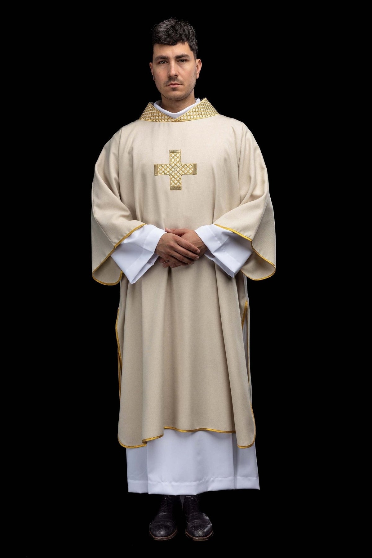 Ecru dalmatic worn full length, showing gold embroidered cross and trim