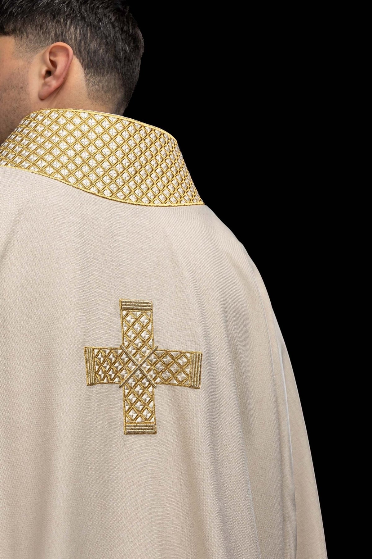 Ecru dalmatic back view with gold embroidered cross and collar