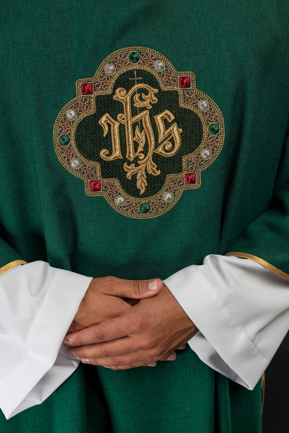 Green dalmatic, close-up of embroidered IHS symbol on the front