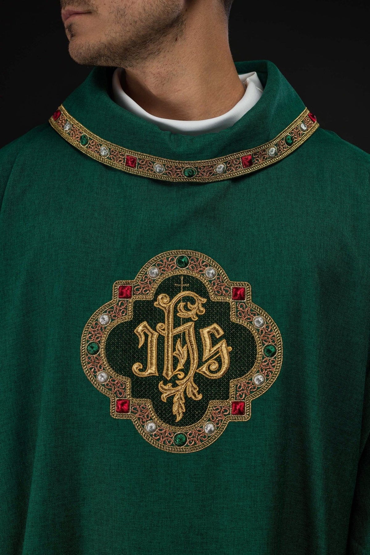 Green dalmatic, close-up of ornate IHS embroidery and gold sleeve trim