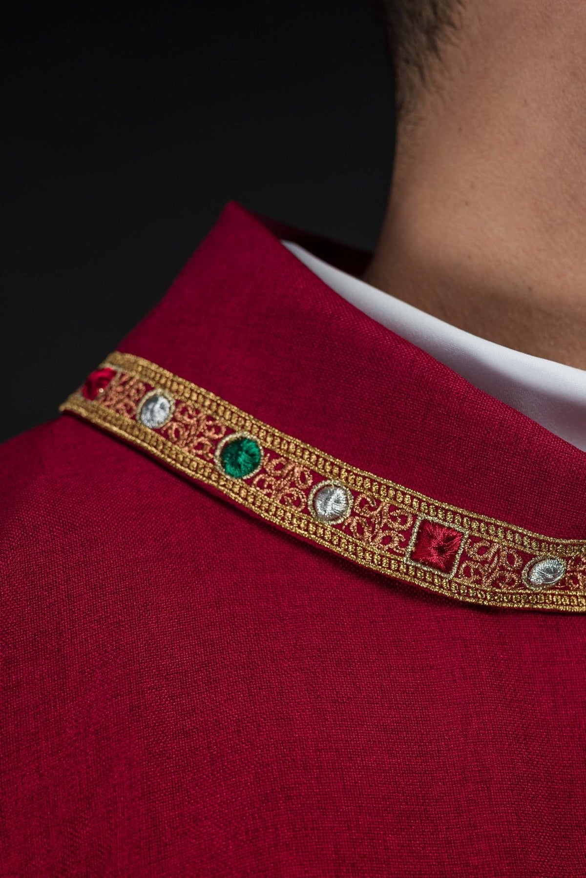 Red dalmatic close-up of red collar with gold trim and multicolour embroidery