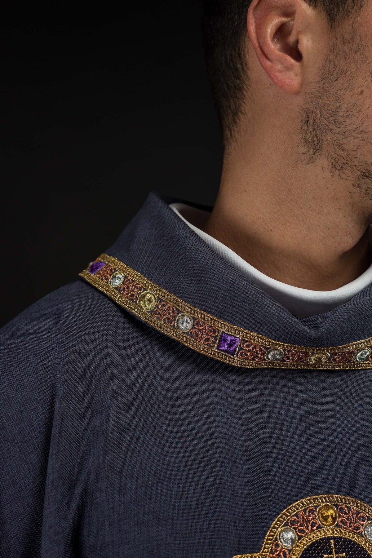 Purple dalmatic close-up showing ornate embroidered collar trim