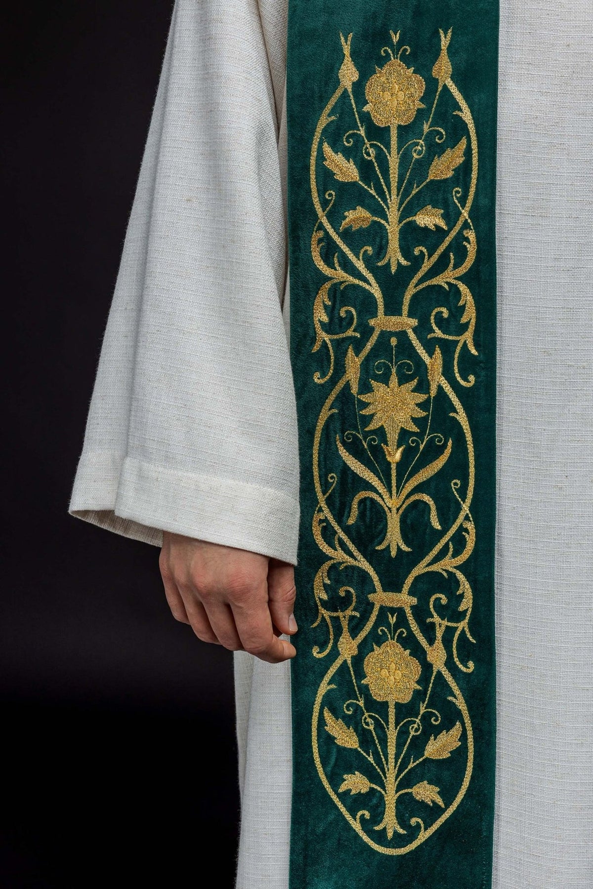 Green stole close-up showing detailed gold floral embroidery