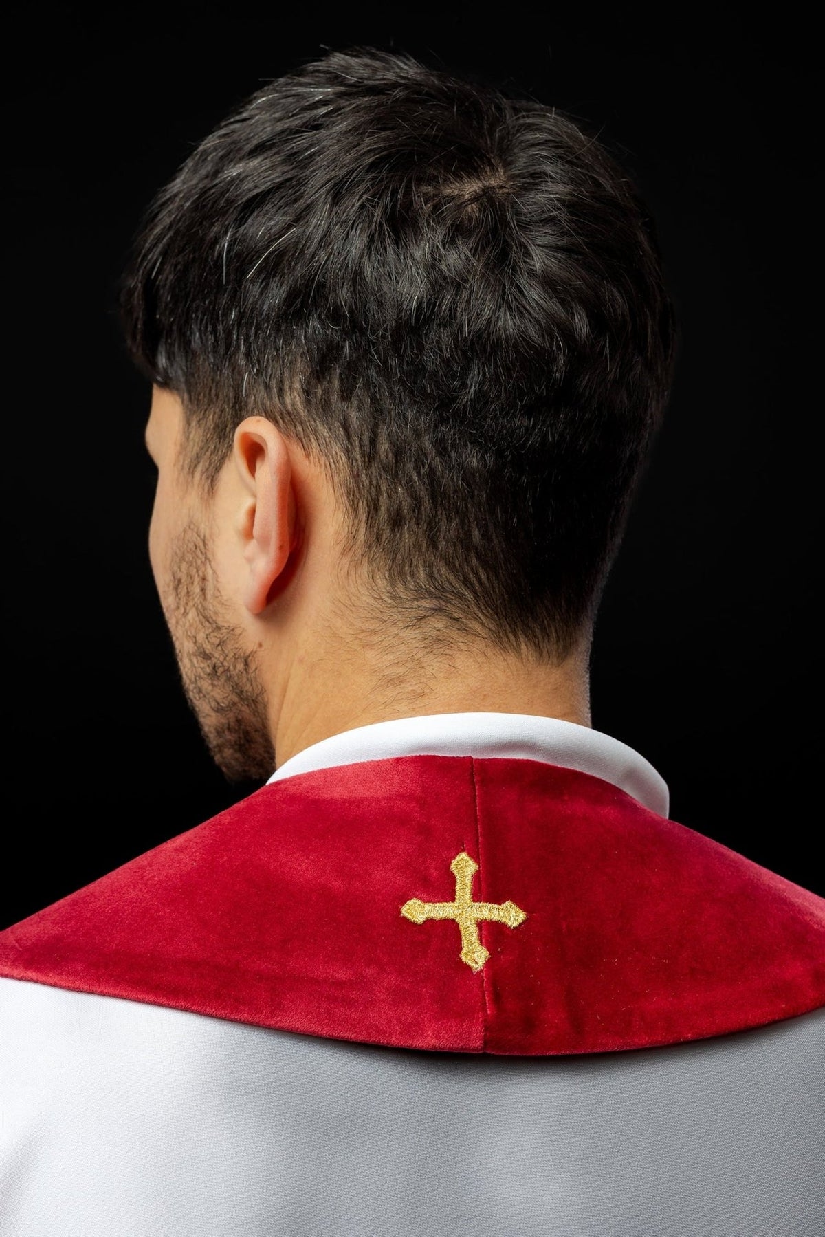 Back view of red stole showing gold embroidered cross at the neck