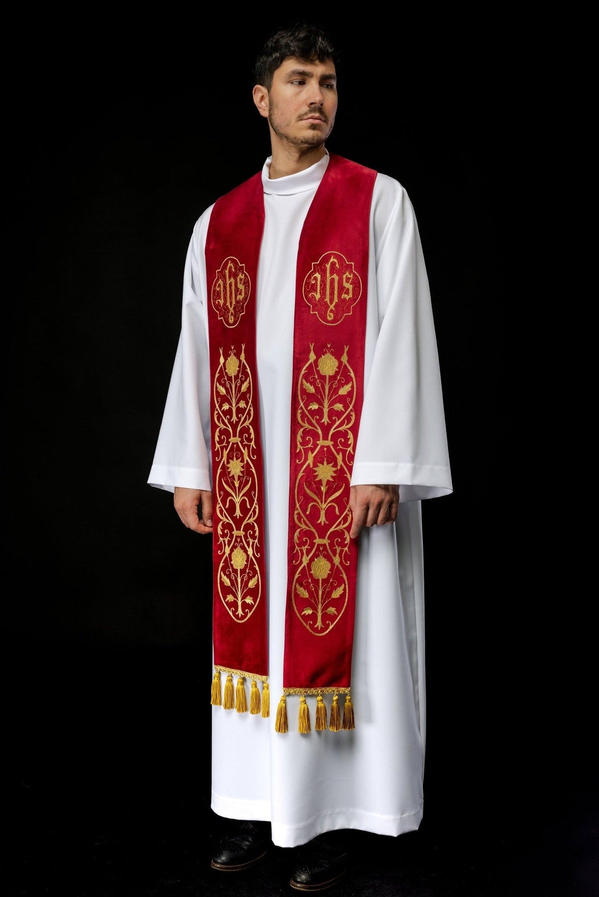 Red IHS stole worn full length, showing one-sided gold embroidery