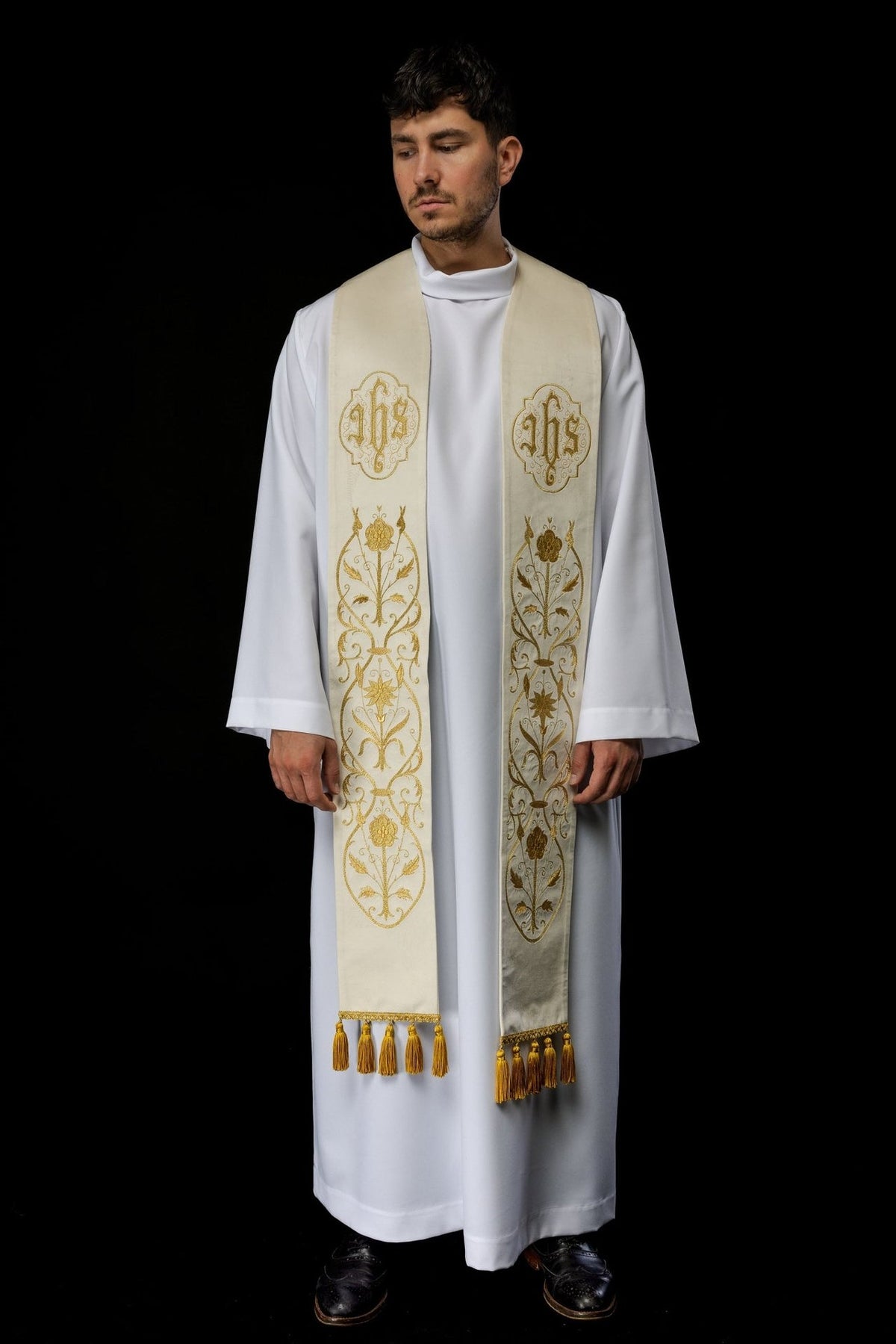 IHS stole worn full length, showing paired gold embroidery and tasselled ends