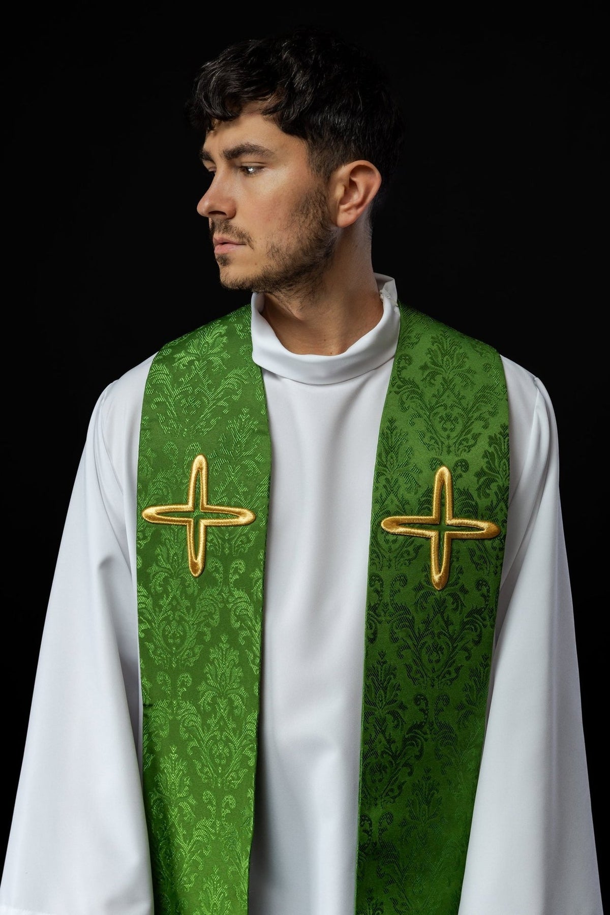 Green embroidered jacquard stole, close-up front view with gold cross motifs
