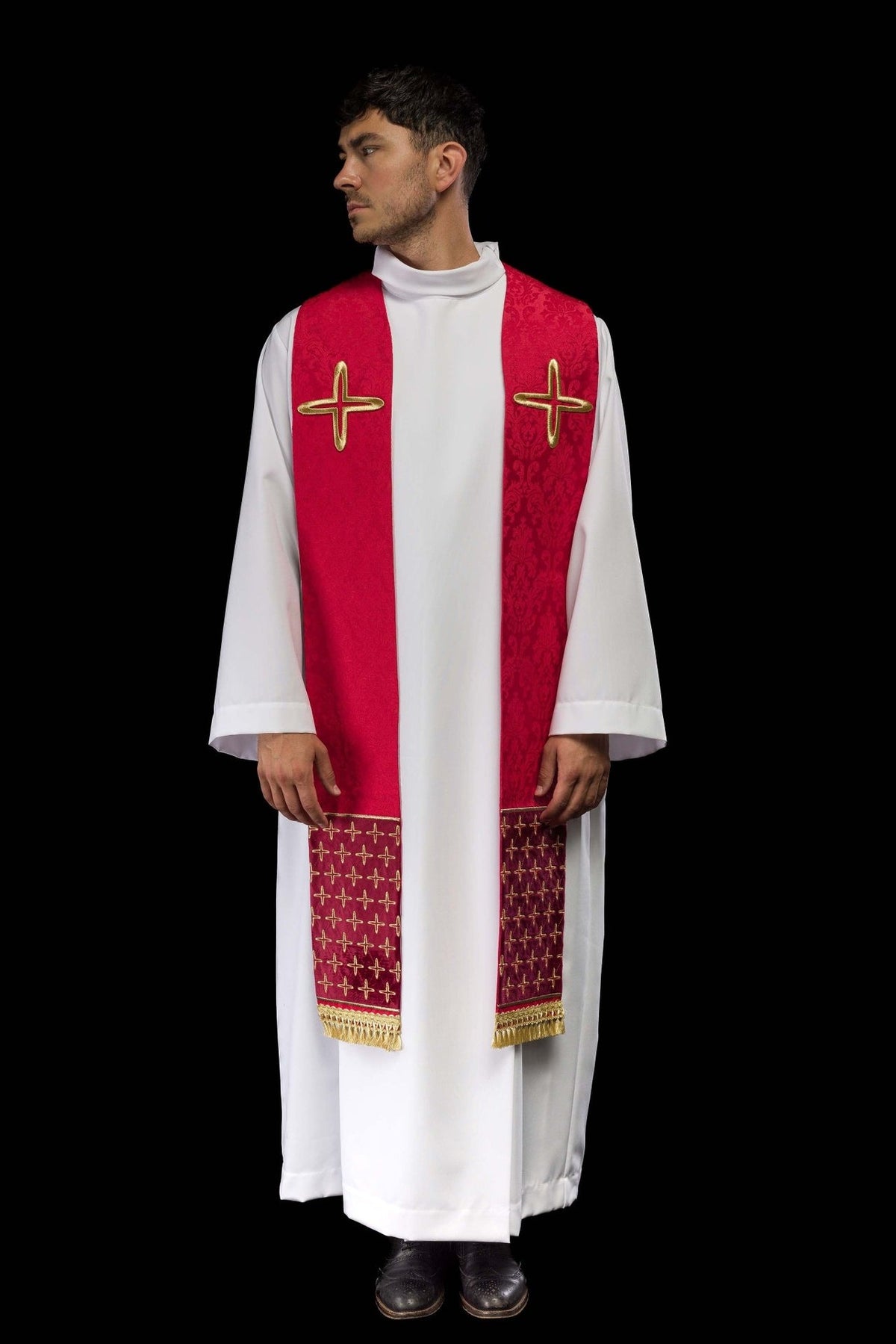Red stole worn front view showing cross motifs, jacquard pattern and gold fringe