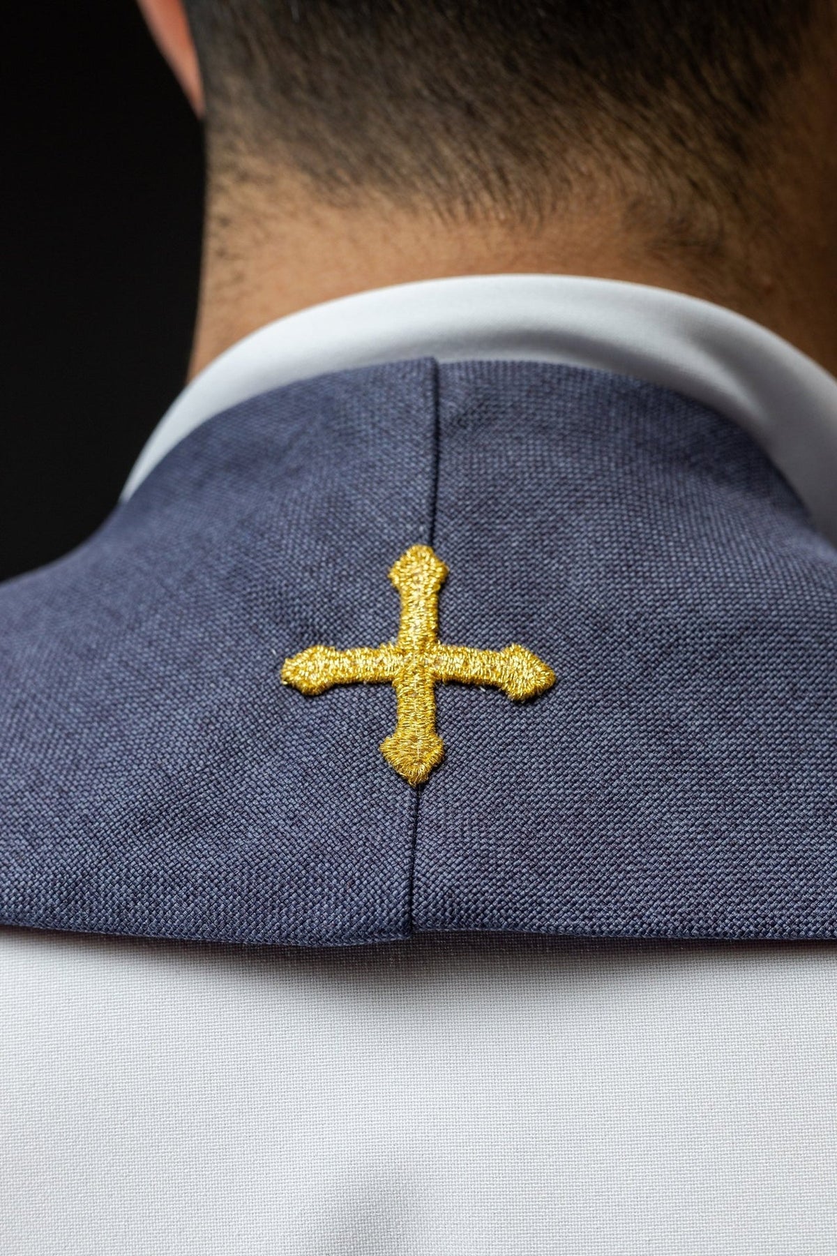 Purple stole neck detail with embroidered gold cross