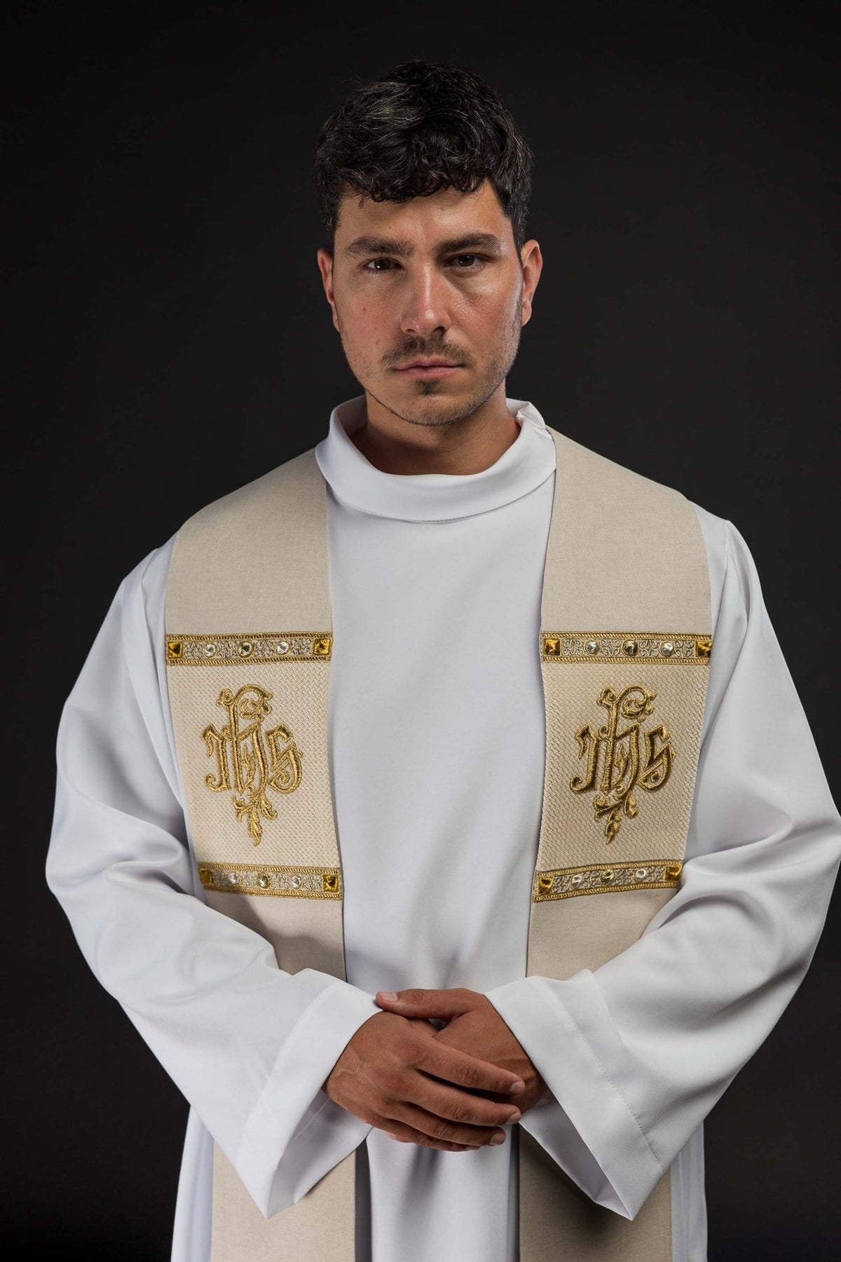 Ecru stole worn close-up, showing gold IHS embroidery and decorative borders