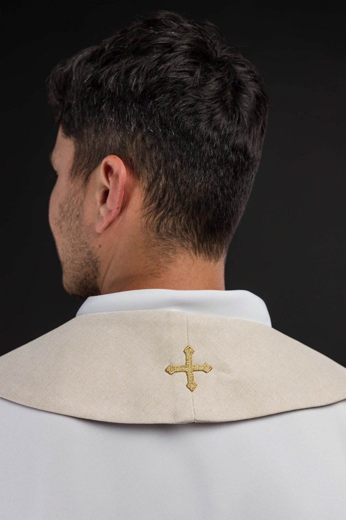 Ecru stole back view showing a small embroidered gold cross near the neck