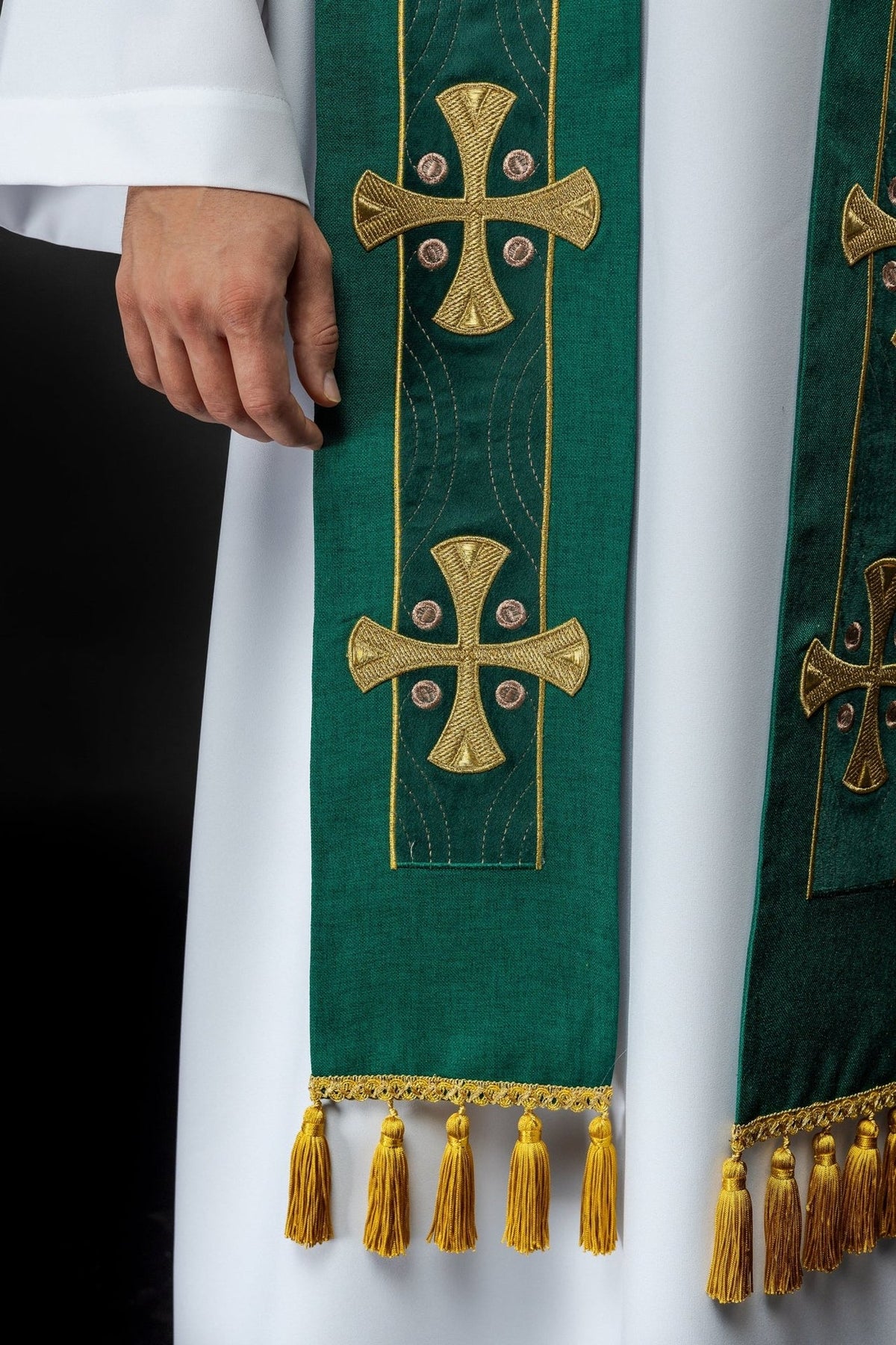 Green stole detail showing two embroidered gold crosses and tassel trim
