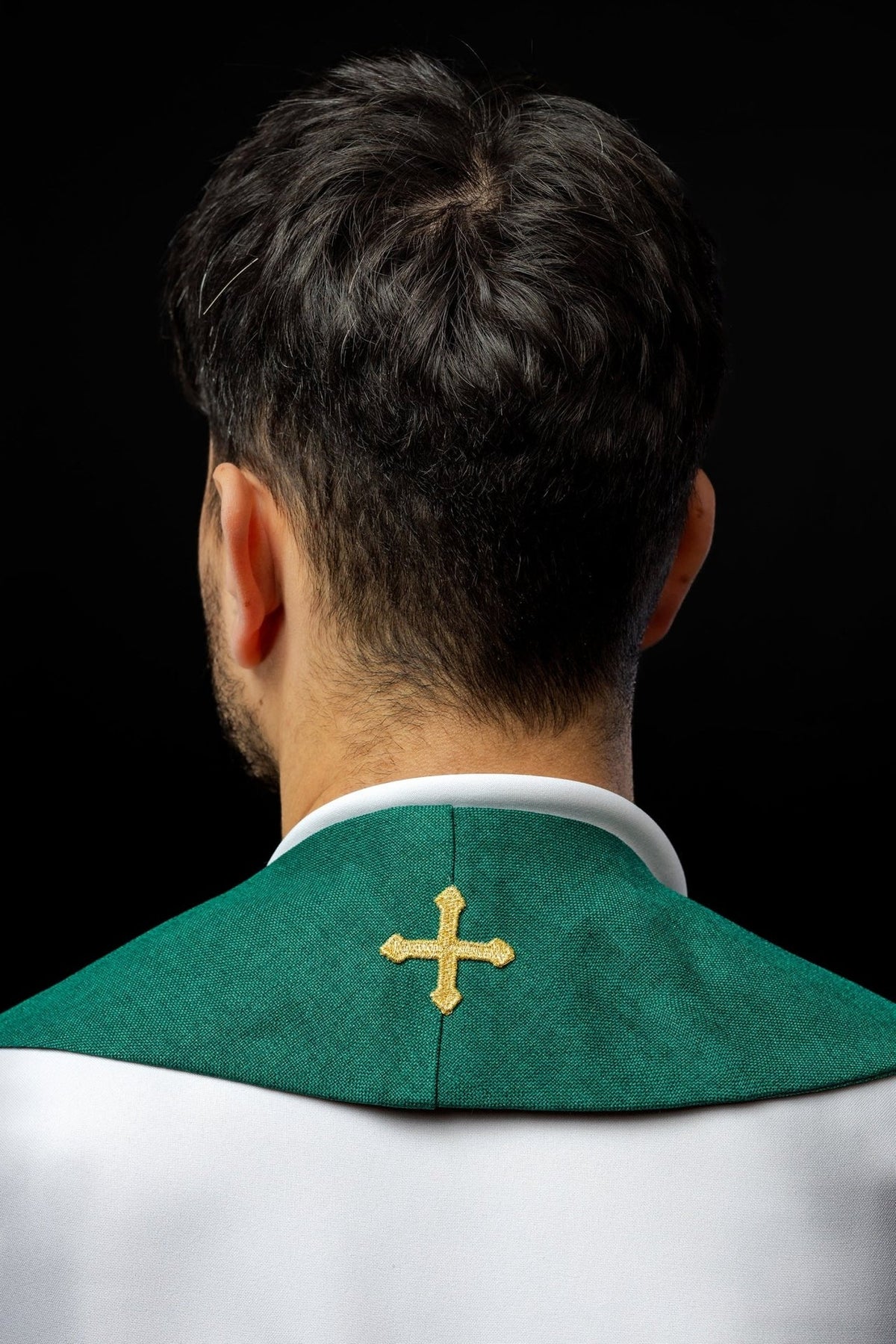 Green stole back view worn with a small embroidered cross at the neck