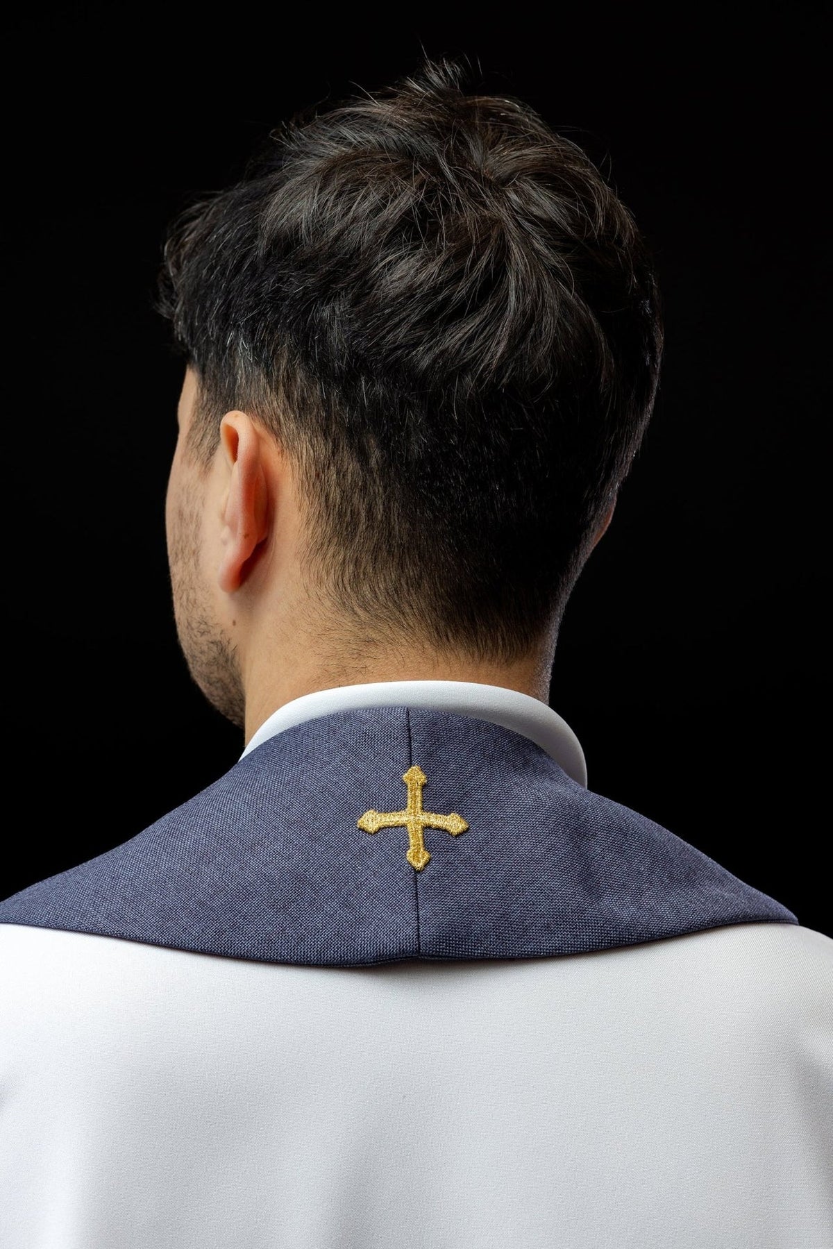 Purple stole back view with a single gold cross embroidery at the neck