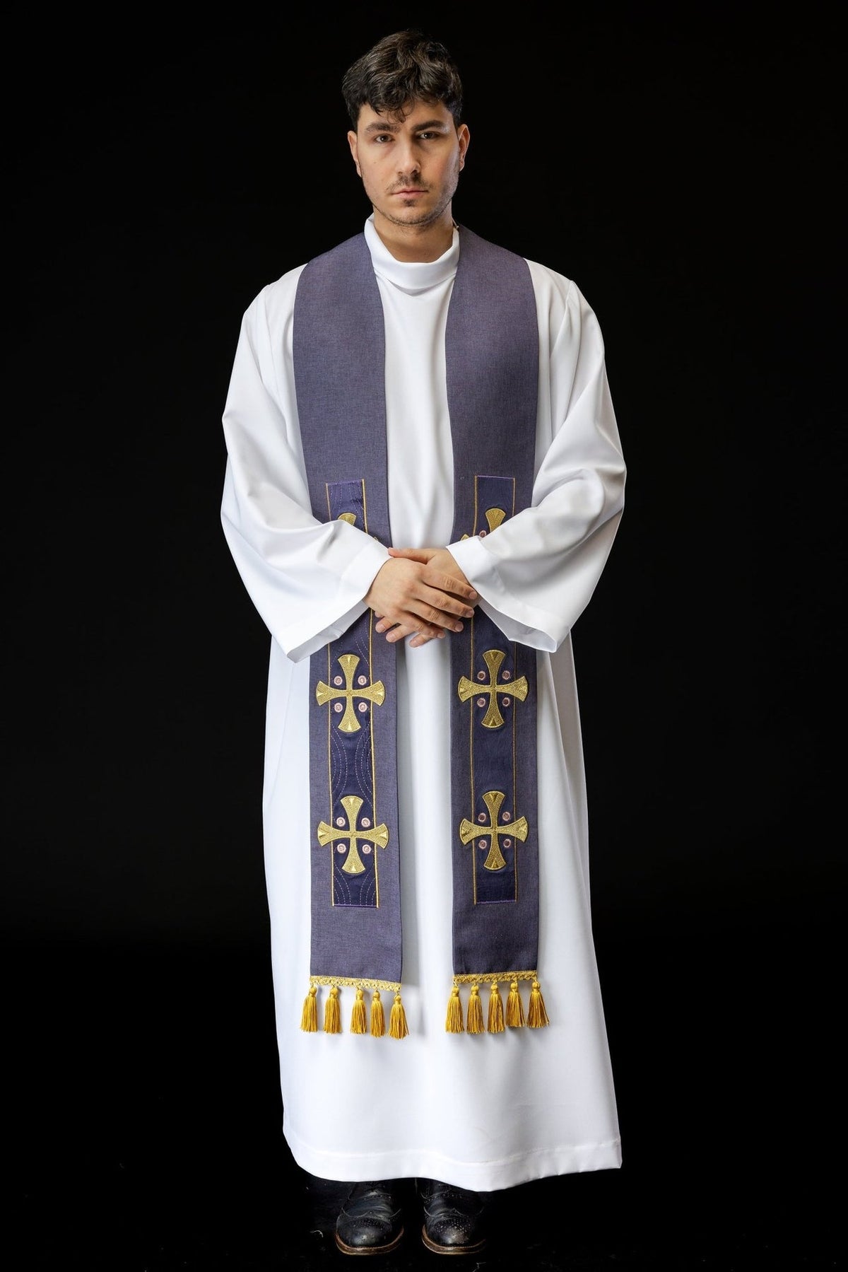 Embroidered purple stole worn front view with repeated cross embroidery and gold tassels