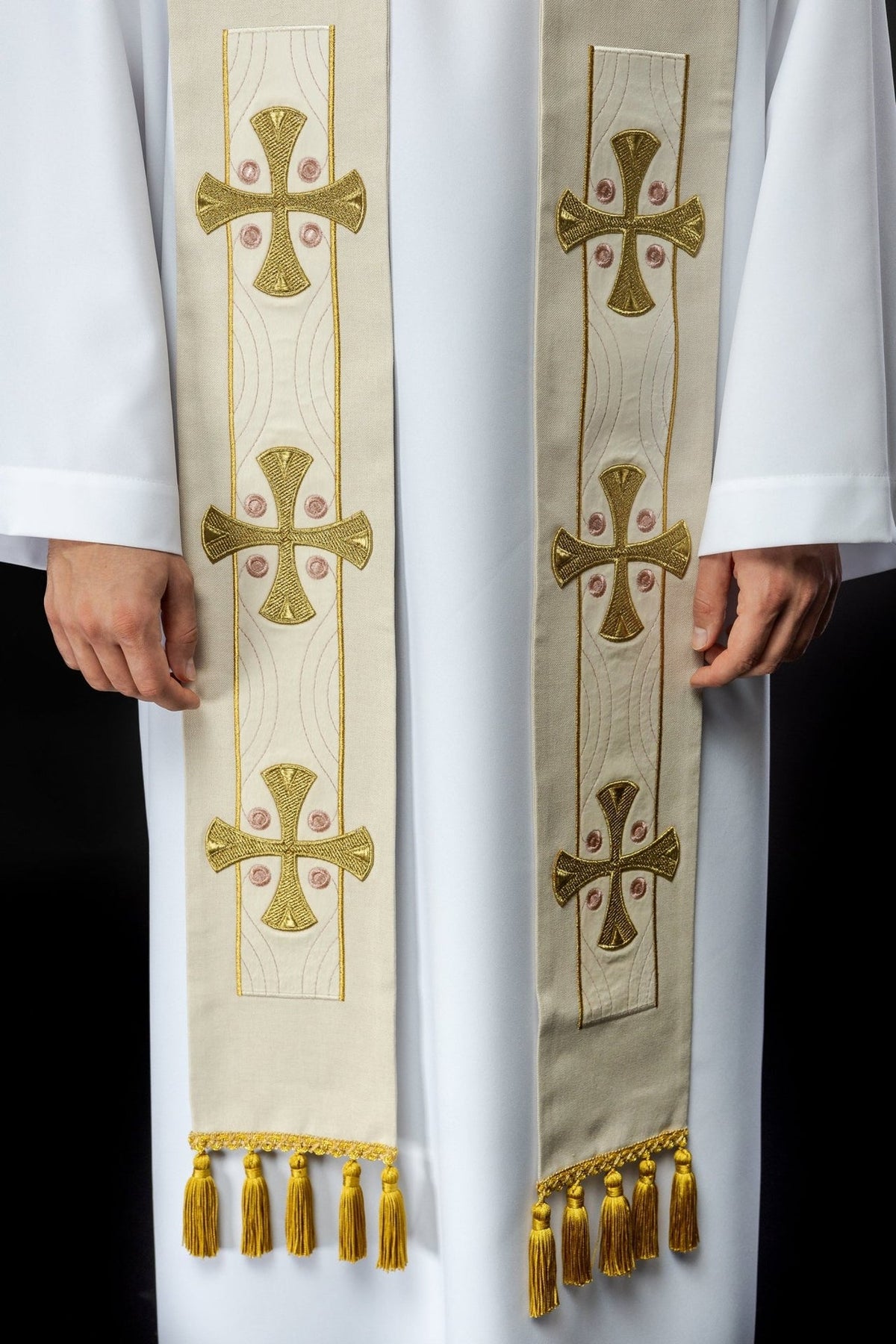 Ecru stole front close-up showing repeated gold crosses and gold tassels