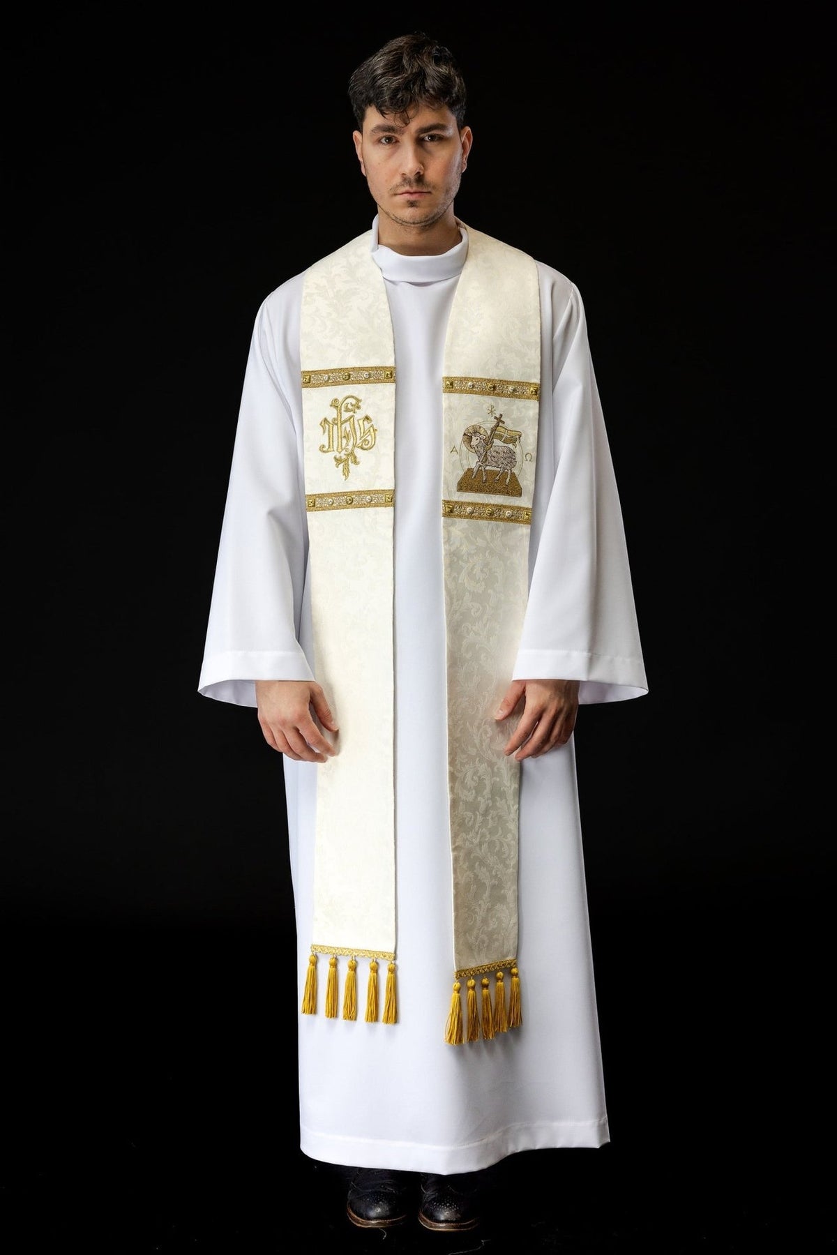 Ecru stole worn front view with Paschal Lamb, IHS and gold tassel embroidery