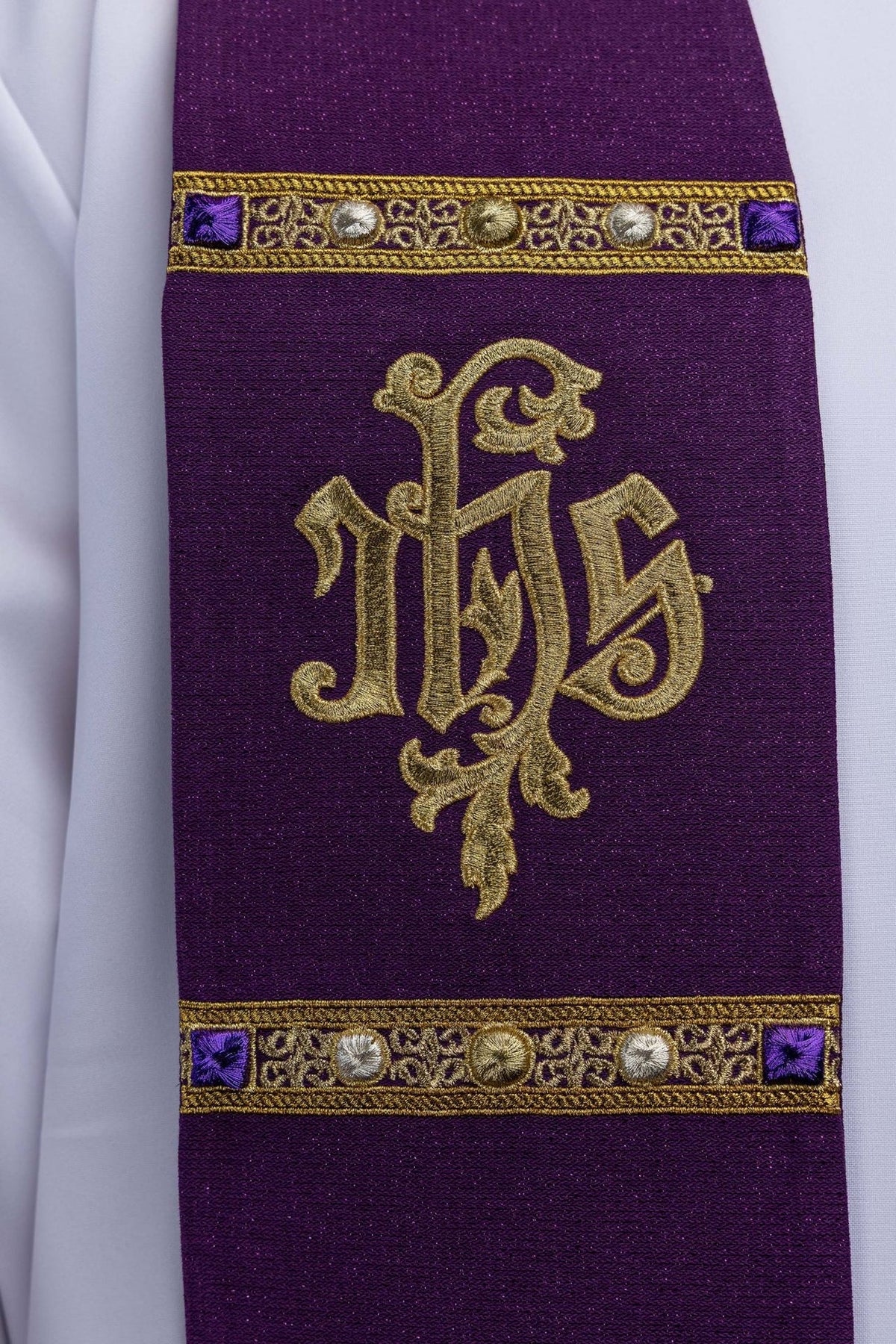 Advent stole close-up with gold IHS monogram, purple fabric and ornate gold embroidery