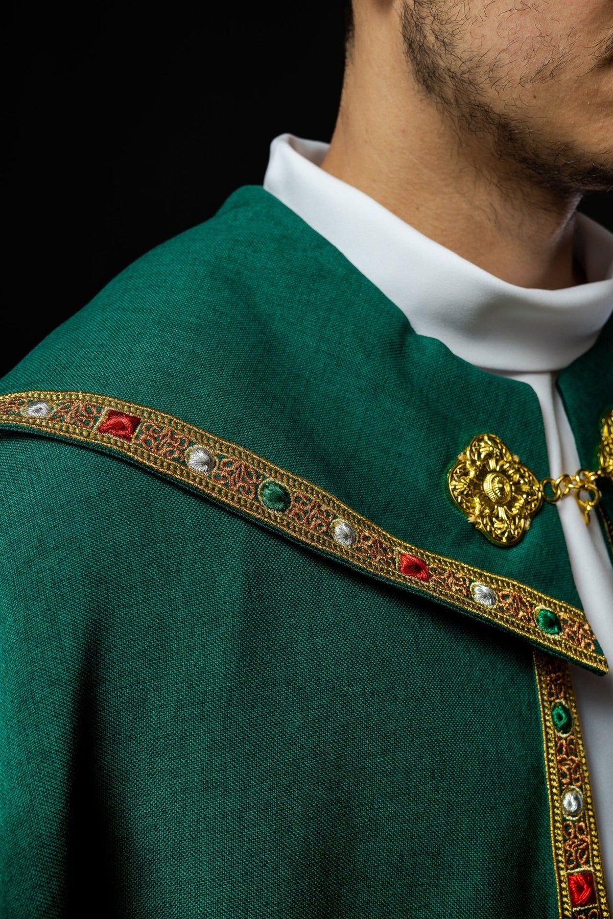 Green cope detail showing ornate gold trim with red, green and silver accents