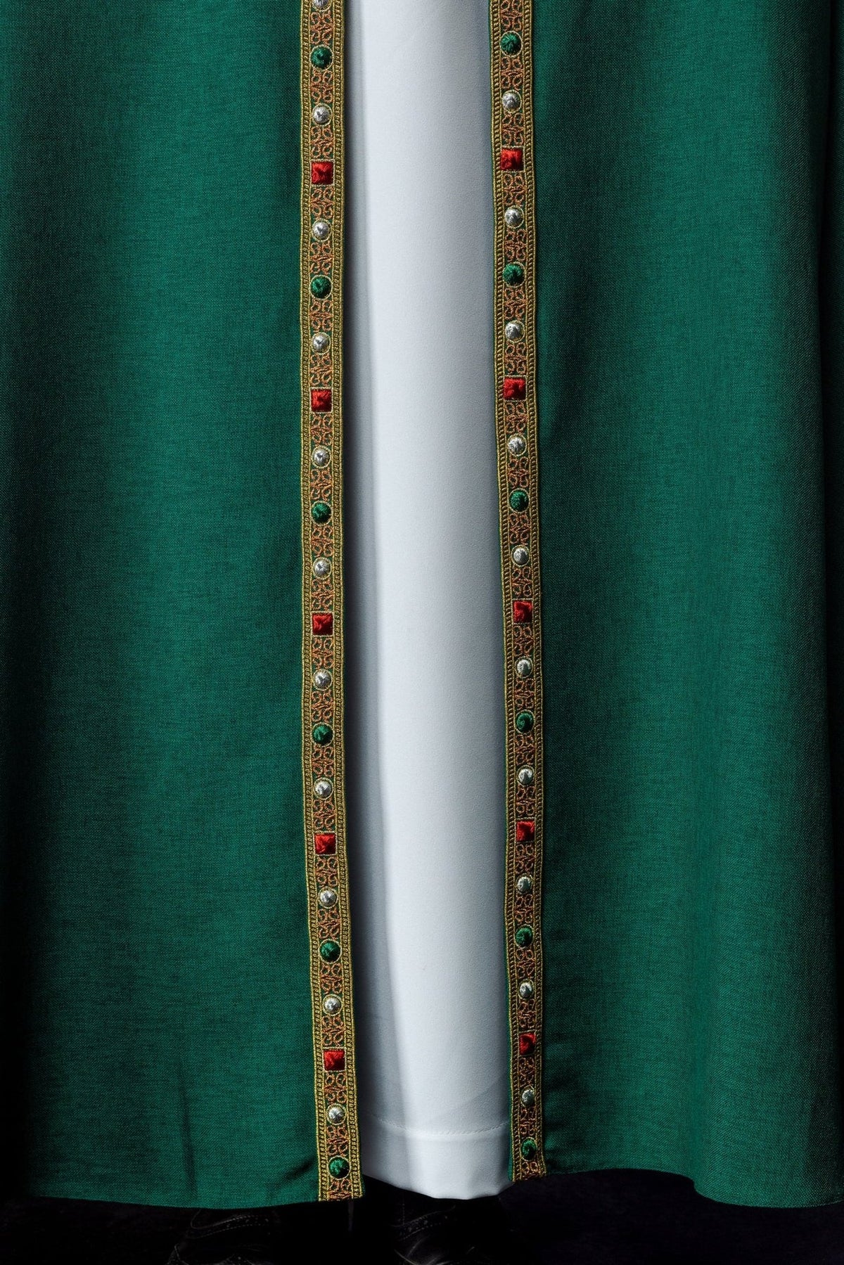 Green cope close-up showing red, green and silver accents on gold trim