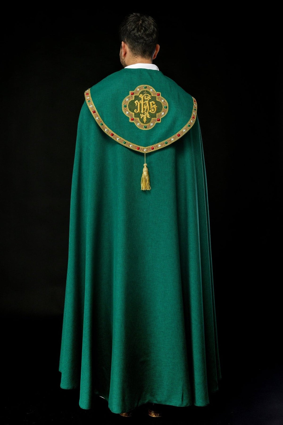 Green cope back view with gold IHS embroidery, ornate trim and tassel