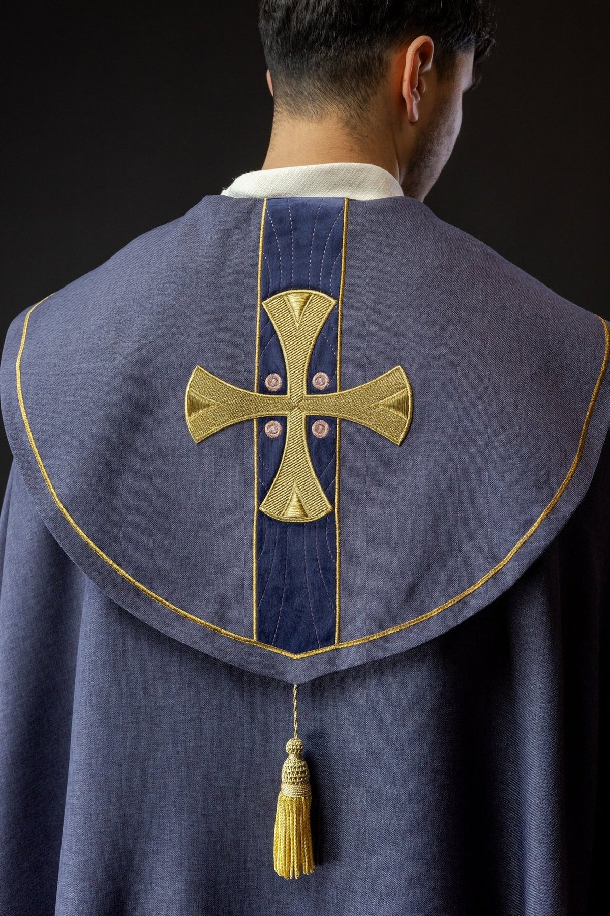 Purple cope back view with embroidered gold cross and tassel