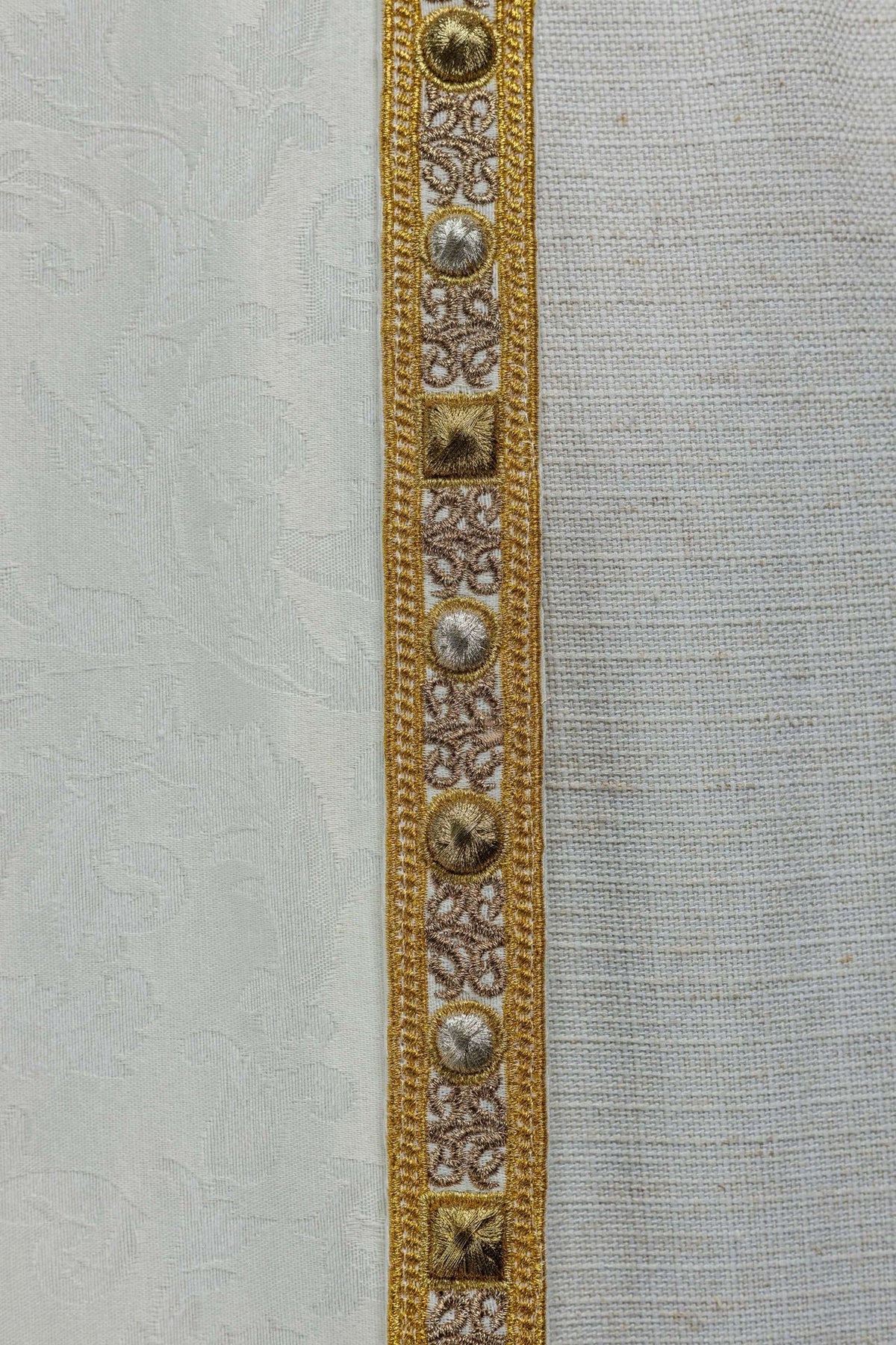 Ecru cope with Paschal Lamb design, close-up of gold embroidery and patterned trim