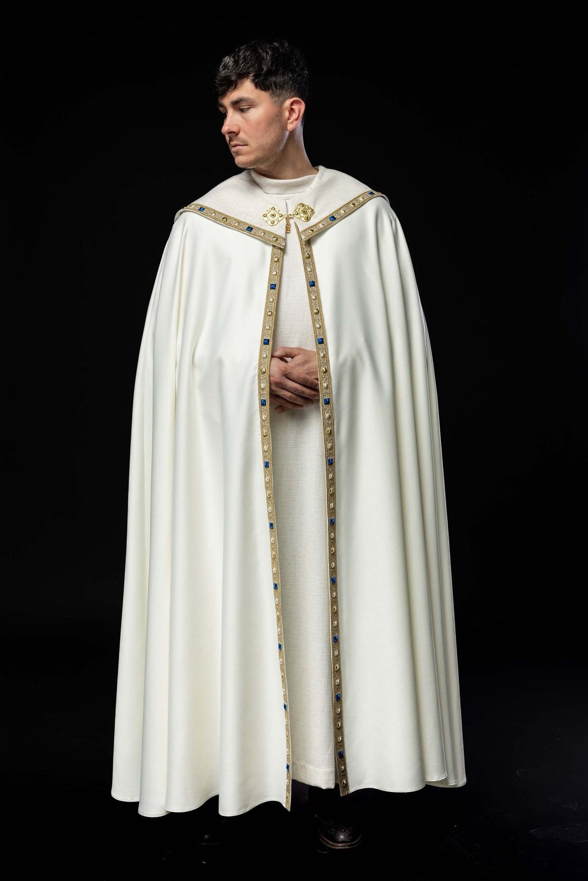 Embroidered cope front view in ecru with gold trim and blue details