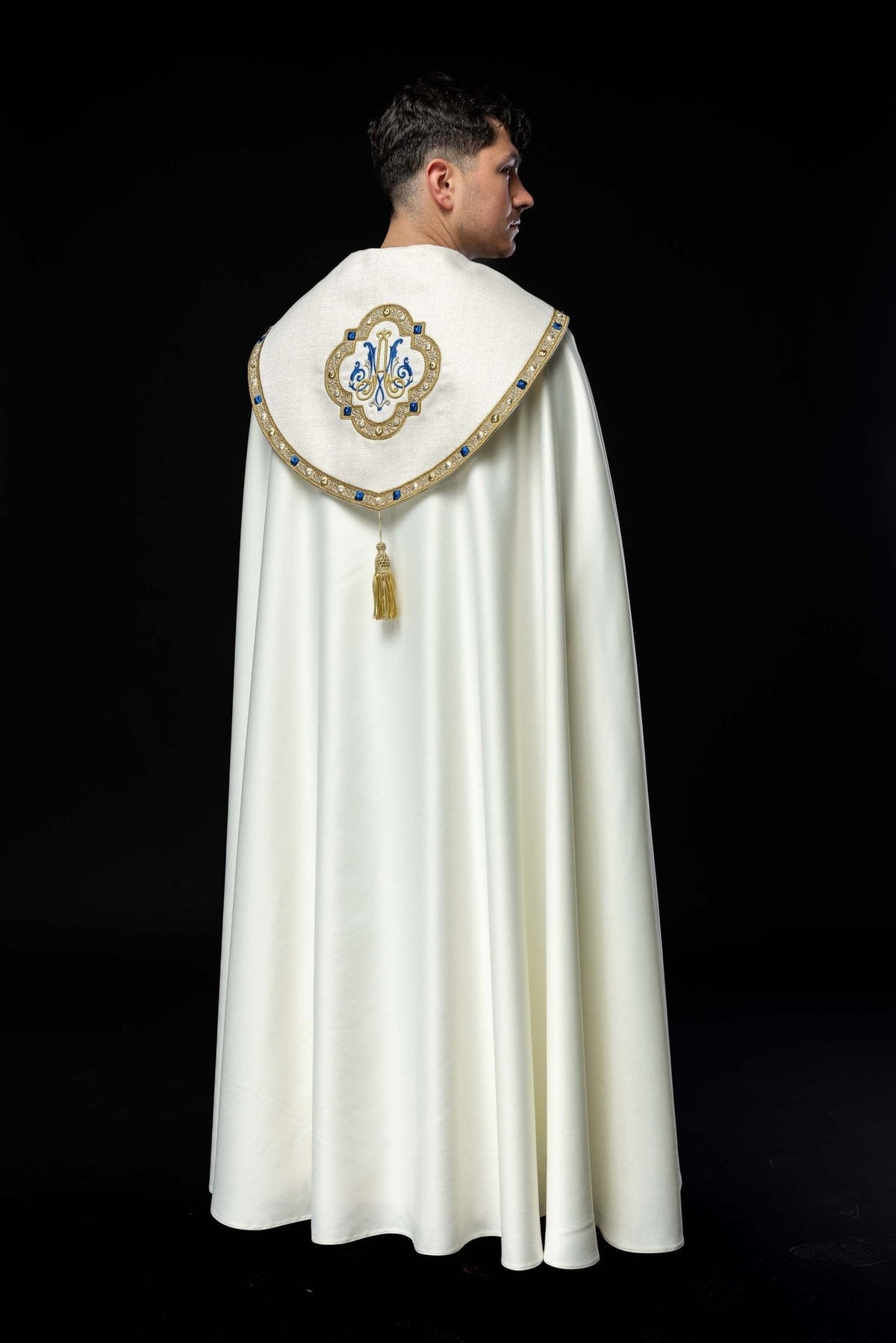 Embroidered cope back view showing Marian monogram, gold trim and tassel