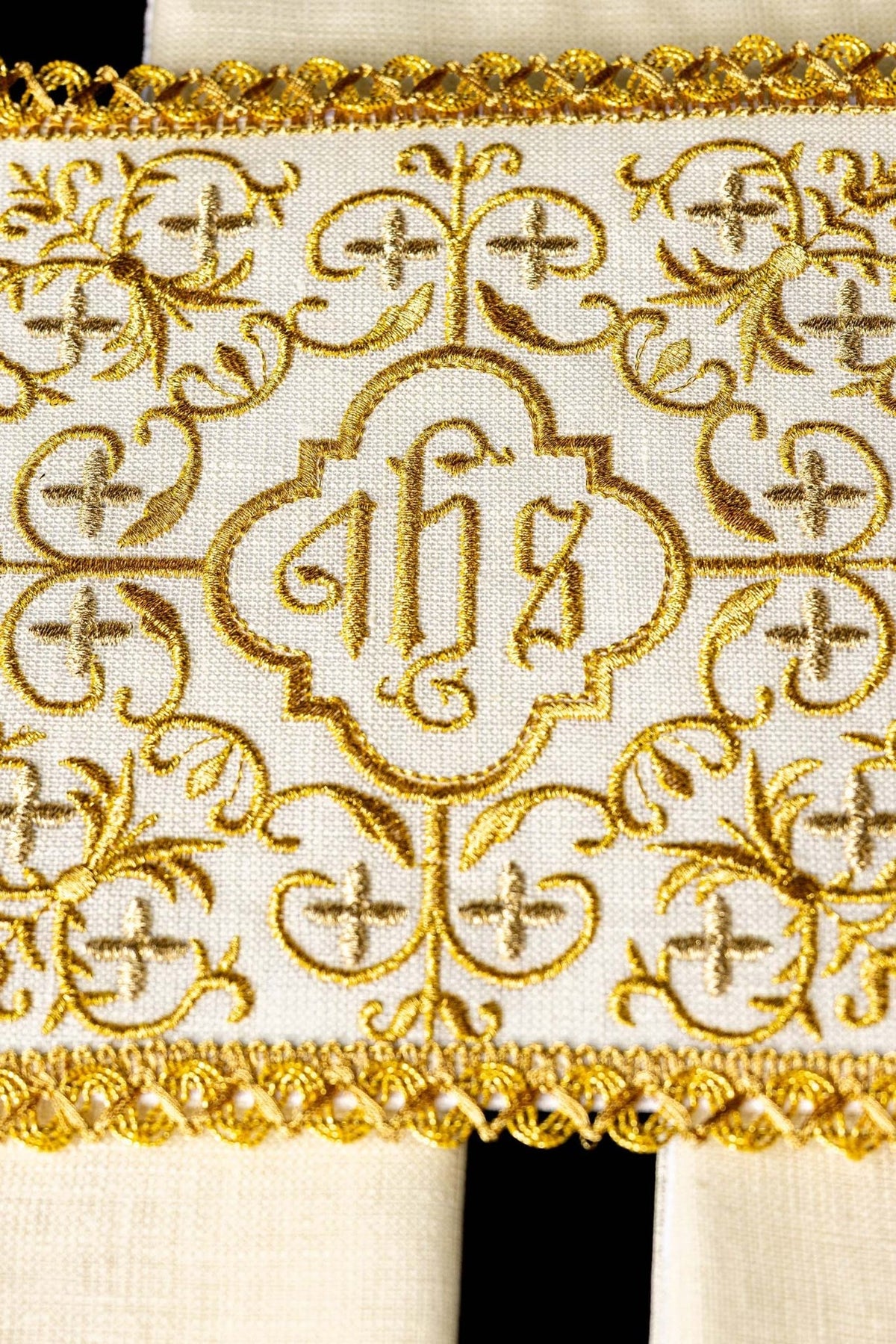 Altar linen set detail showing gold JHS embroidery, crosses and ornate floral scrollwork