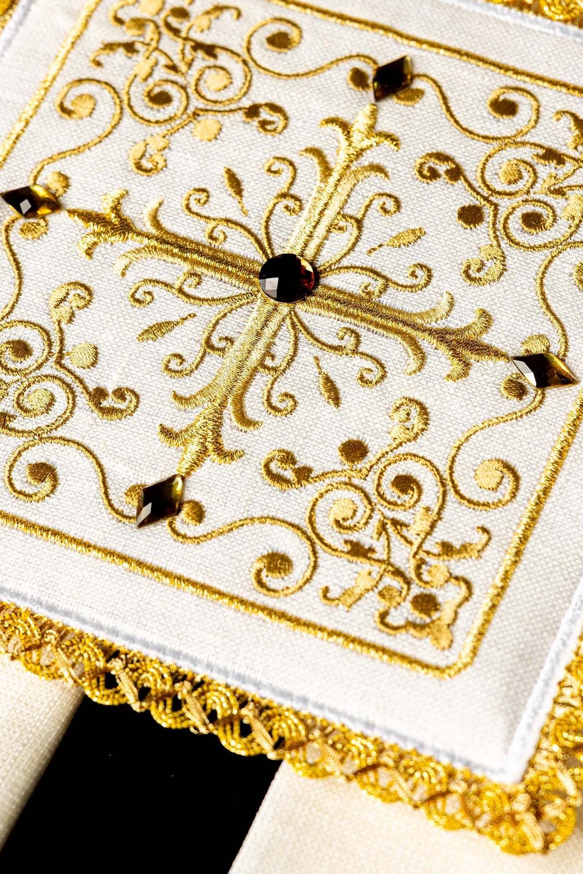 Altar linen set close-up showing ornate gold cross embroidery with dark decorative accents